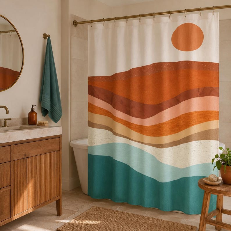 May include: A shower curtain featuring a horizontal layered landscape design with a large orange circle representing the sun. The pattern includes wavy bands of terracotta, rust, tan, cream, and teal colors printed on a white fabric background.