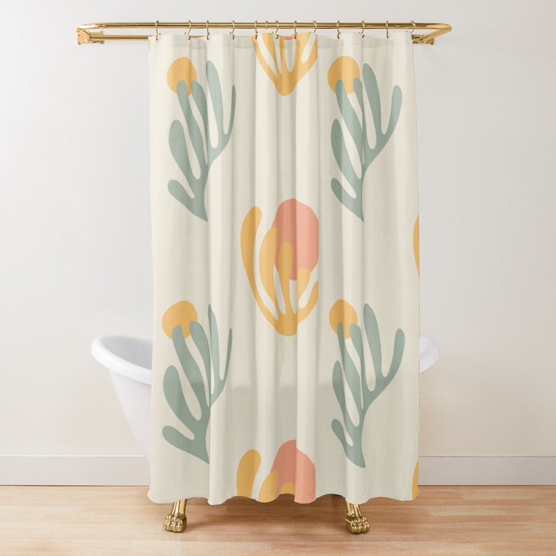 May include: A shower curtain with a repeating pattern of stylized flowers in shades of yellow, pink, and green on a cream background.