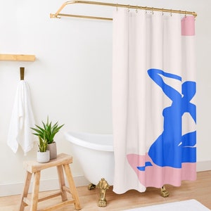 May include: A shower curtain with a pink and blue abstract design. The design features a blue silhouette of a person sitting on a pink surface.