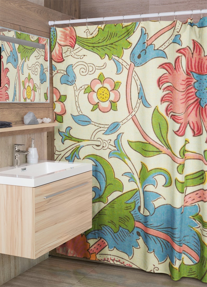 May include: A shower curtain featuring a floral design in shades of pink, blue, green and yellow on a cream background. The pattern includes stylised flowers and leaves.
