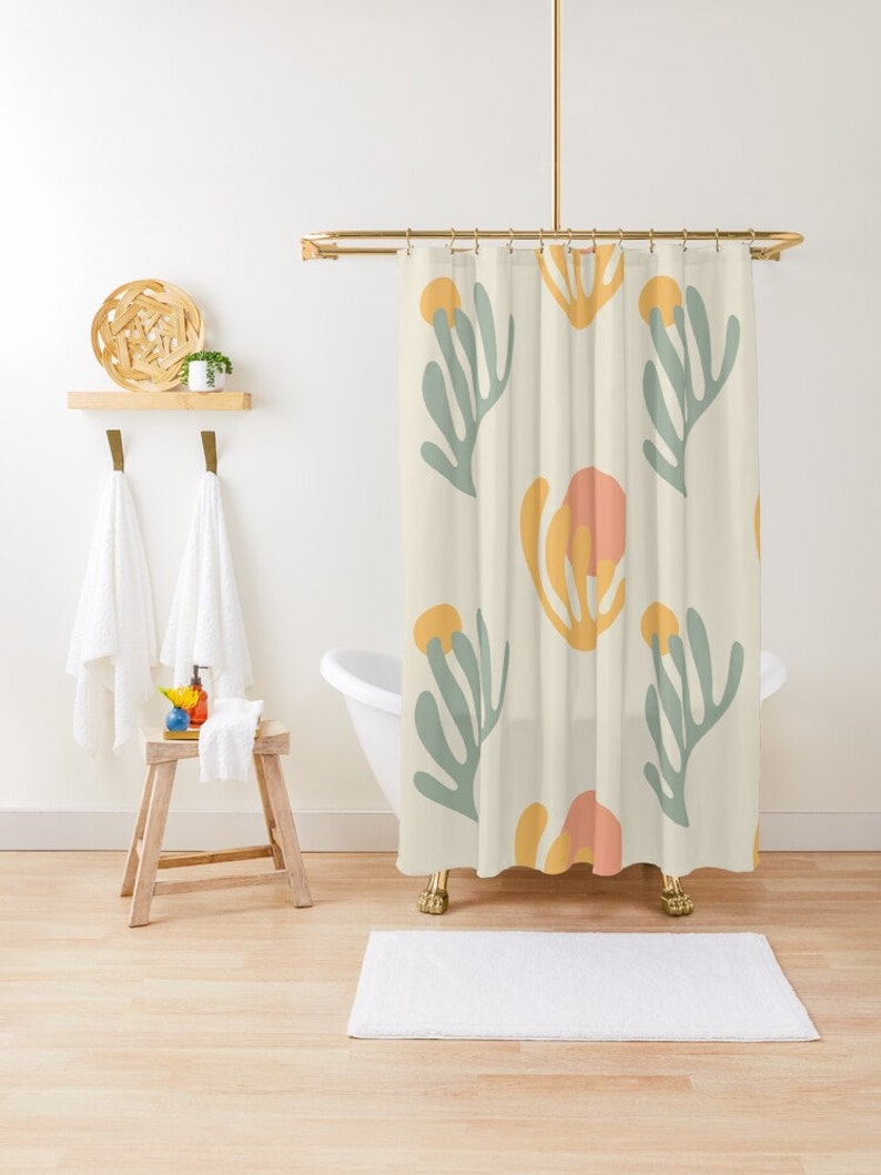 May include: A shower curtain with a cream background and a repeating pattern of abstract green, yellow, and pink floral shapes.
