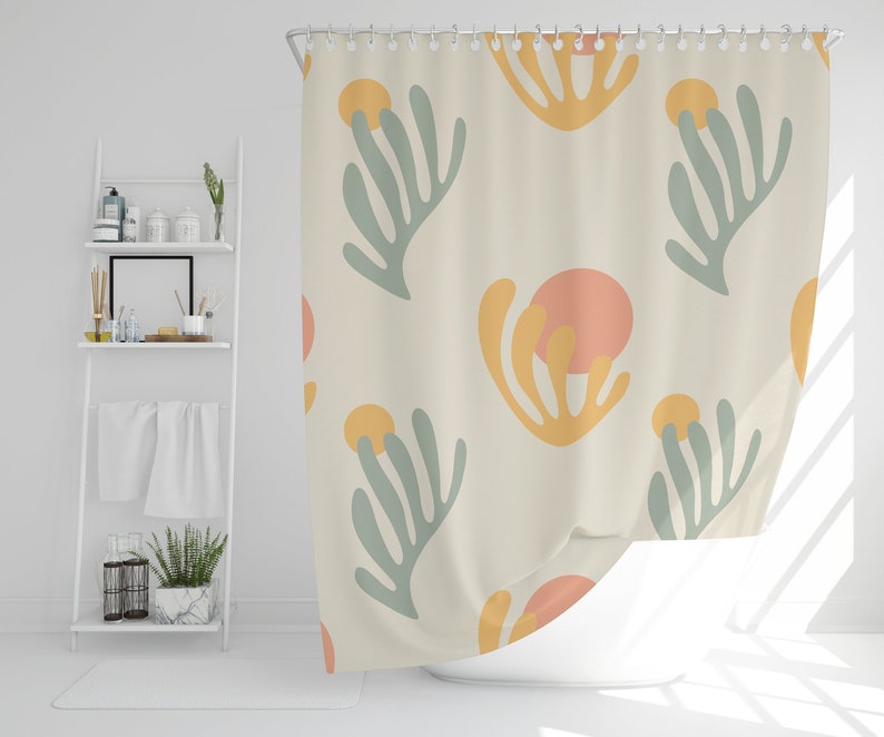 May include: A shower curtain with a cream background and a repeating pattern of abstract green, yellow, and orange shapes.
