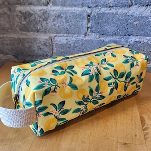 cosmetic bag, makeup bag, toiletry bag, travel bag, pencil case.