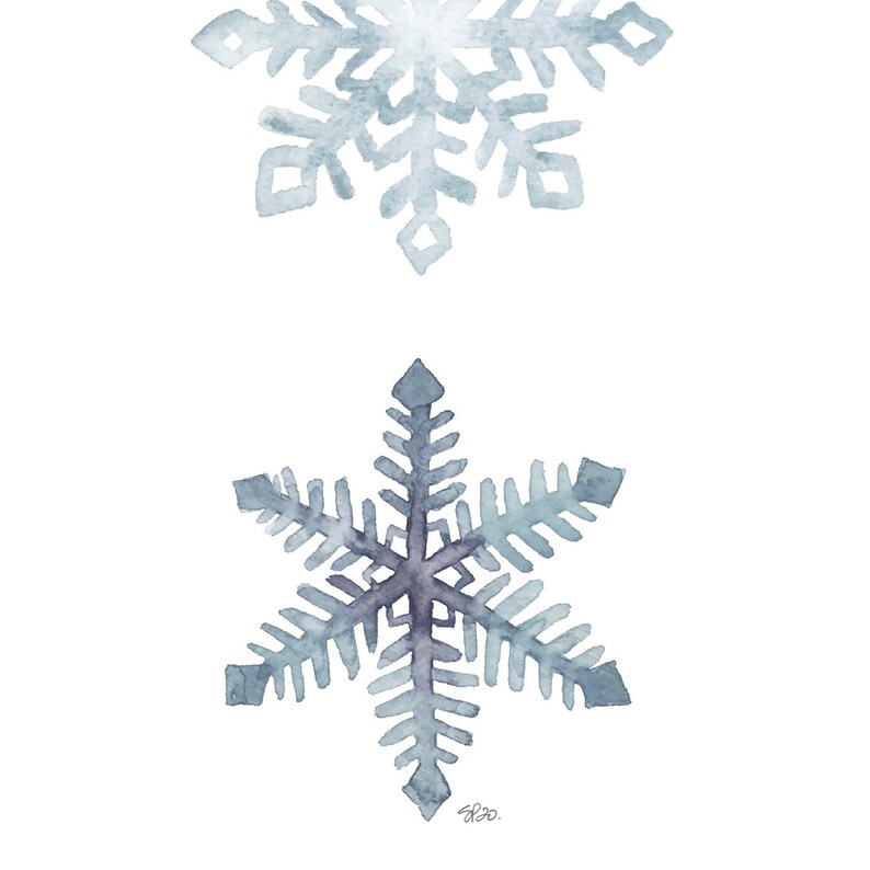 May include: Two watercolour snowflakes in shades of blue and grey. The top snowflake is smaller and more detailed, while the bottom snowflake is larger and simpler.