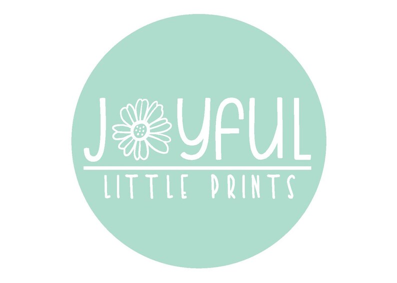 May include: A round, light teal graphic with the words "JOYFUL LITTLE PRINTS" in white, stylized font. A white daisy graphic is on the left side of the word "JOYFUL".