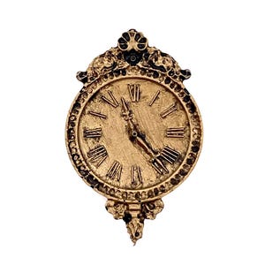 May include: A gold-toned wall clock with Roman numeral markings and ornate detailing around the face. The clock has a black background and gold-colored hands.