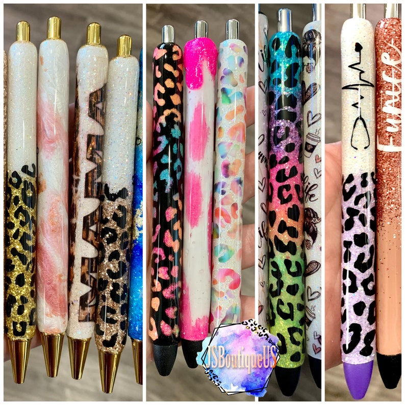 May include: A collection of ten colorful pens with various designs, including animal print, glitter, and abstract patterns. The pens have gold accents and black ink.
