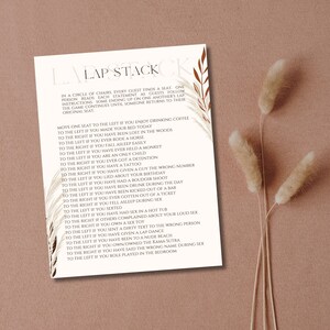 May include: A printable game card with a brown background and beige text. The card features a list of prompts for a game called "Lap Stack". The game instructions are to move one seat to the left or right based on the prompt.  The card is decorated with brown and beige illustrations of leaves and branches.