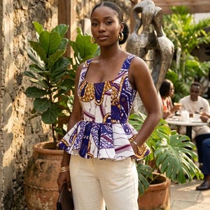 May include: A sleeveless peplum top featuring a vibrant geometric pattern in shades of deep purple, mustard yellow, and white, paired with light beige trousers. The top has a square neckline and a flared waist, worn with gold hoop earrings.