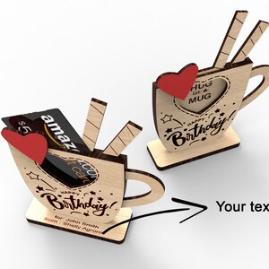 May include: Wooden mug shaped birthday card with a gift card slot and the text "Happy Birthday!" and "Hug in a Mug".