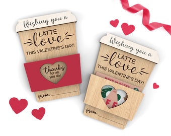 May include: Two wooden coffee cup gift cards with the text "Wishing you a latte love this Valentine's Day!" and a space to write "from:". One card has a red sleeve with a heart-shaped tag that says "thanks for all you do!" The other card has a gift card slot with a heart-shaped cutout.