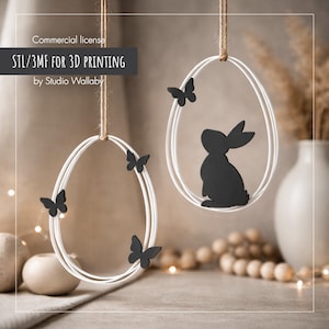 May include: Two white oval ornaments with black butterfly and bunny cutouts, suspended by twine. The text "STL/3MF FOR 3D PRINTING" is visible. These ornaments are likely for Easter or spring decoration.
