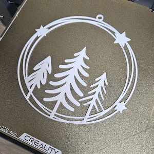 3D printable wreath STL file layered pine trees inside a circular frame with stars for Christmas or winter holiday decoration