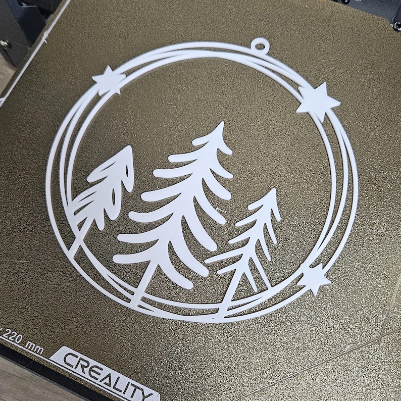 3D printable wreath STL file layered pine trees inside a circular frame with stars for Christmas or winter holiday decoration