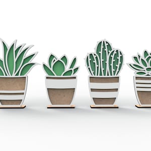 May include: Set of four wooden cutout succulent and cactus plants in white pots with brown accents. The plants are green and the pots have a striped pattern.