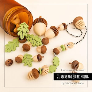 May include: A collection of 21 acorn and oak leaf shaped beads in shades of brown, beige, and light green. Some beads are strung on black and white twine, while others are loose near an amber jar. Text reads: Commercial license 21 BEADS FOR 3D PRINTING by Studio Wallaby.
