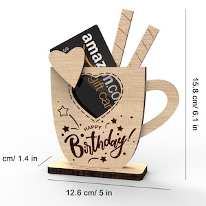 May include: Wooden mug shaped gift holder with a heart cutout and the words "Happy Birthday!"  The mug is 6.1 inches tall and 5 inches wide.  A gift card is shown inside the mug.