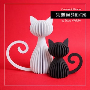 May include: Two decorative cat figurines, one white and one black, stand against a red background. The white cat is larger, with a curled tail. Both cats have a ribbed design. Text at the top reads "STL 3MF FOR 3D PRINTING by Studio Wallaby."