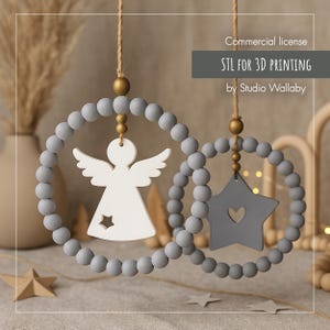 May include: Two hanging wooden ornaments. One is a white angel with a star cutout, the other is a gray star with a heart cutout. Both are suspended by twine and gray beaded rings. The text "STL FOR 3D PRINTING" is visible.