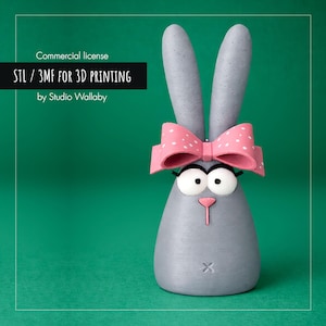 Könnte beinhalten: Eine graue Hasenfigur mit einer rosa Schleife mit weißen Punkten. Der Hase hat große Augen, eine rosa Nase und einen kleinen Mund. Der Text auf dem Bild lautet "STL / 3MF FOR 3D PRINTING by Studio Wallaby."