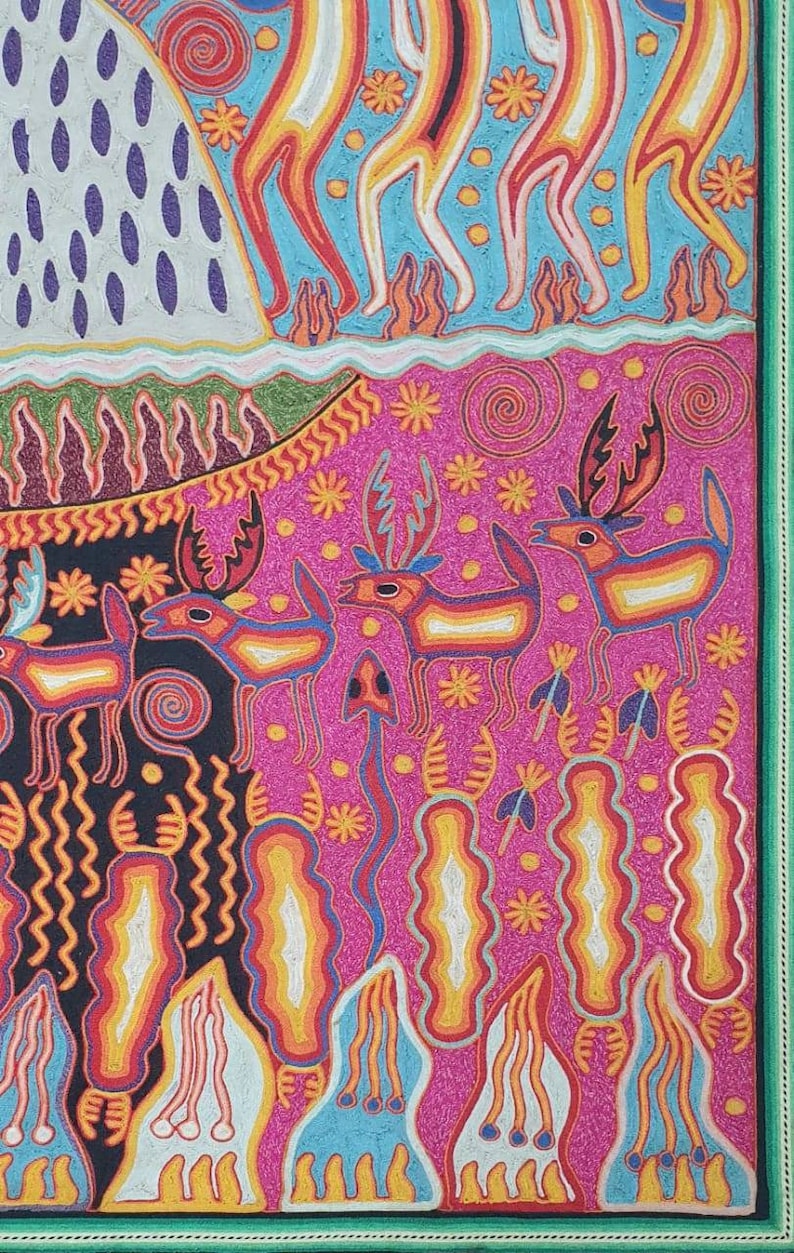 May include: A colorful, hand-stitched textile art piece depicting a scene with stylized figures and animals. The background is a vibrant blue with yellow dots, and the foreground features a pink landscape with deer and other creatures. The artwork is framed with a green border.