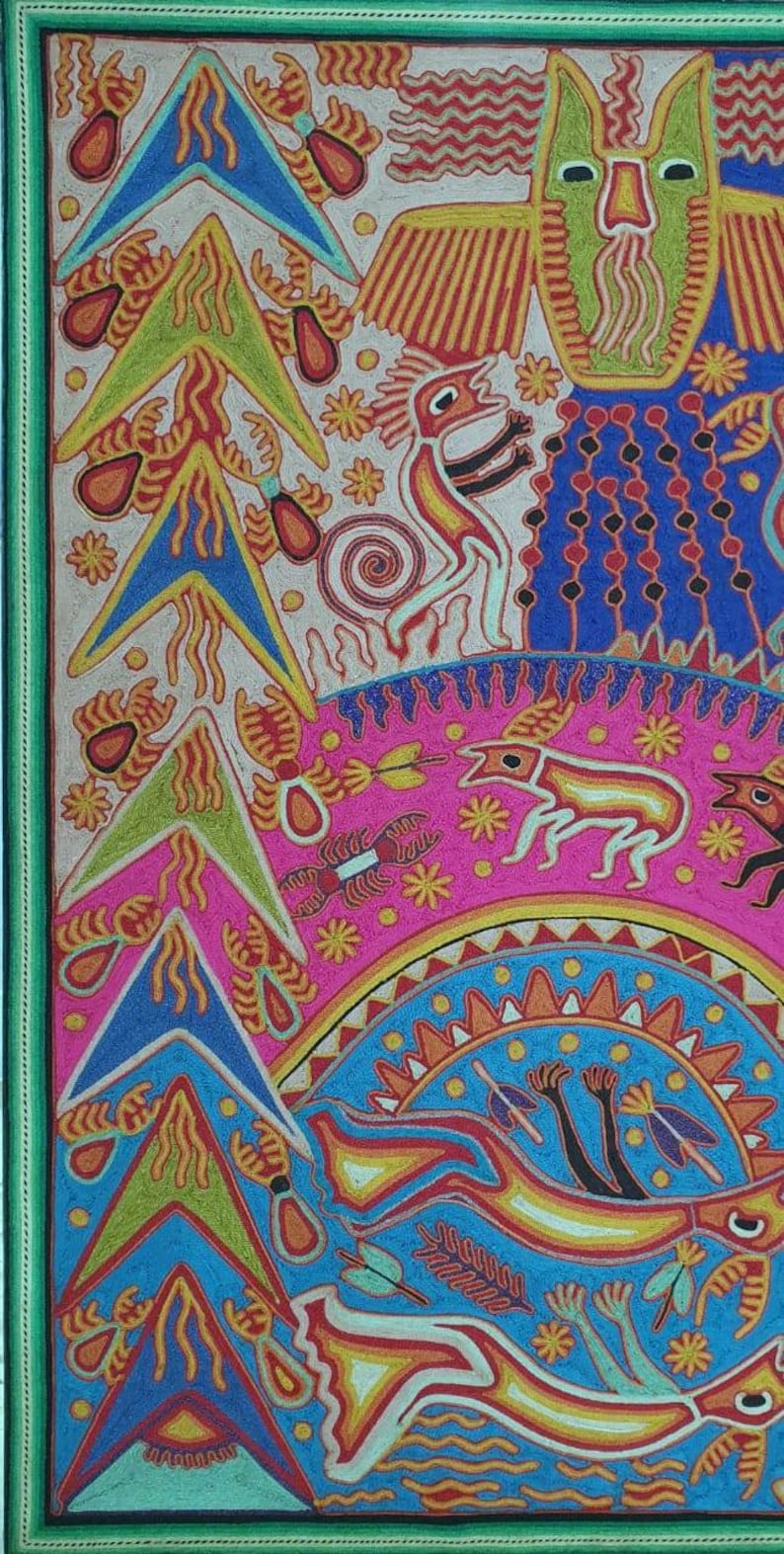 May include: A colorful, hand-stitched artwork depicting a variety of animals and plants. The artwork features a green owl with a yellow beak, a red and yellow bird, a pink and white deer, and a blue and yellow fish. The artwork is framed in a green frame.