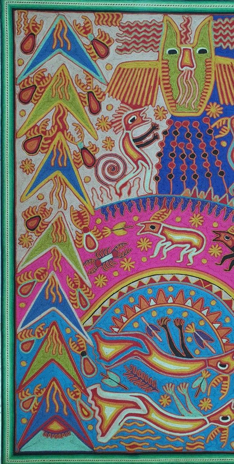 May include: A colorful, hand-stitched artwork depicting a variety of animals and plants. The artwork features a green owl with a yellow beak, a red and yellow bird, a pink and white deer, and a blue and yellow fish. The artwork is framed in a green frame.