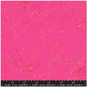 May include: Bright pink fabric with a speckled pattern in shades of gold, red, and pink. The fabric has a ruler along the bottom edge with the text "RUBY STAR SOCIETY". This fabric is suitable for quilting and sewing projects.