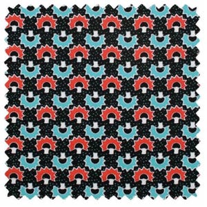May include: A black fabric with a repeating pattern of red and blue stylized sun shapes. The background is black with white dots.