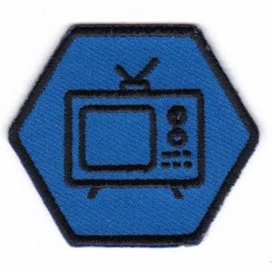 May include: Blue hexagonal patch with a black outline and a black and white image of a vintage television set.