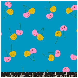 May include: A fabric with a repeating pattern of cartoon cherries in pink and yellow on a bright blue background. Each cherry has a smiling face. The text "RUBY STAR SOCIETY" is at the bottom.
