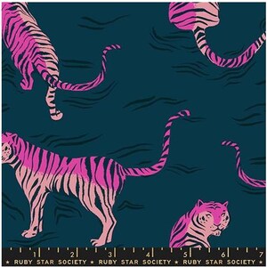 May include: A dark teal fabric featuring a repeating pattern of pink and light pink tigers with black stripes. The bottom edge includes a black border with a white ruler scale and the repeating text Ruby Star Society with small stars.