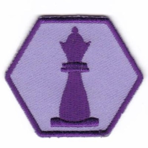 May include: Purple felt iron-on patch in the shape of a hexagon with a purple chess queen silhouette in the center.