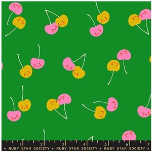 May include: Green fabric with a repeating pattern of cartoon cherries. The cherries are pink and yellow with smiling faces and white stems. The text "RUBY STAR SOCIETY" is at the bottom.