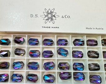 May include: A box of 48 iridescent purple glass beads, each measuring 12mm x 8mm. The box is labeled "Corona Art. 5204 HELIOTROPE D.S. & Co. TRADE MARK Made in Austria".