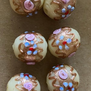Q1, early 1900s cream wedding cake beads with blue and red forget me Nots.