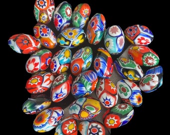 May include: A collection of colorful, oval-shaped glass beads with intricate floral and geometric patterns. The beads are a mix of red, blue, green, yellow, and white.