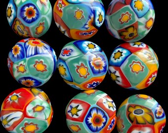 May include: Nine colorful glass ornaments with a geometric pattern of blue, green, red, white, and yellow. The ornaments have a floral design.