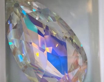 May include: A clear iridescent teardrop-shaped crystal pendant with a hole at the top for hanging.