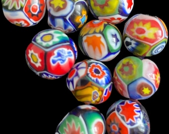 May include: A collection of 10 colorful glass beads with a geometric pattern. The beads are multi-colored with red, yellow, blue, green, and white.