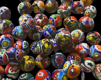 May include: A collection of colorful glass beads with intricate floral patterns. The beads are round and have a glossy finish. They are perfect for jewelry making or other craft projects.