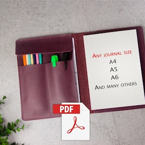 May include: A burgundy leather journal cover with a zipper closure and a pen holder. The cover is open to reveal a blank page with the text "ANY JOURNAL SIZE A4 A5 A6 AND MANY OTHERS". The image also includes a PDF icon.