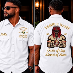 May include: A white short-sleeved button-down shirt featuring embroidered text and graphics. The front displays 'Noble', 'Temple Name', 'No. 00', and 'Oasis of City Desert of State'. The back features a large graphic of a pharaoh figure.