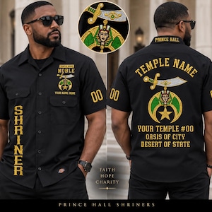 May include: A black short-sleeved button-down shirt featuring gold embroidered text and symbols. The front displays SHRINER, NOBLE, and temple details. The back features a large emblem with a sword, pharaoh head, and star, plus custom text.