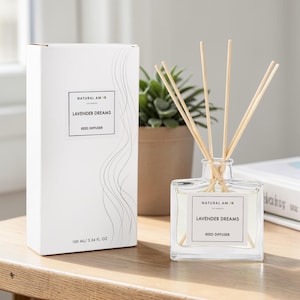 May include: A square glass reed diffuser with wooden reeds, labeled "LAVENDER DREAMS" and "NATURAL AMOR". The product is in a white box with the same label and a decorative design. The diffuser contains 3.34 fl oz of liquid.