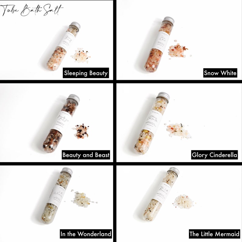May include: Five clear glass tubes filled with different colored bath salts. The tubes are labeled with the names "Sleeping Beauty", "Snow White", "Beauty and Beast", "Glory Cinderella", and "In the Wonderland".