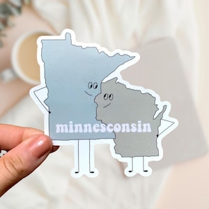 May include: A sticker of the states of Minnesota and Wisconsin, with the states drawn as cartoon characters holding hands and smiling at each other. The text "minnesconsin" is written below the characters.