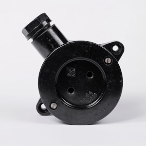 May include: Black electrical outlet box with a round opening and two holes. The box has a label that reads "6A 250V" and "U.S.S.R."