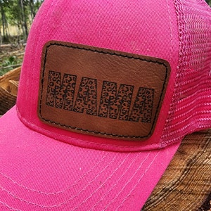 May include: Pink trucker hat with a brown leather patch that says "MAMA" in a leopard print font.