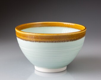 Porcelain bowl in aqua glaze with gold-coloured rim 12.5cm wide x 7.5cm tall